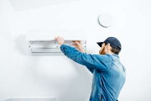 man servicing split system air conditioner